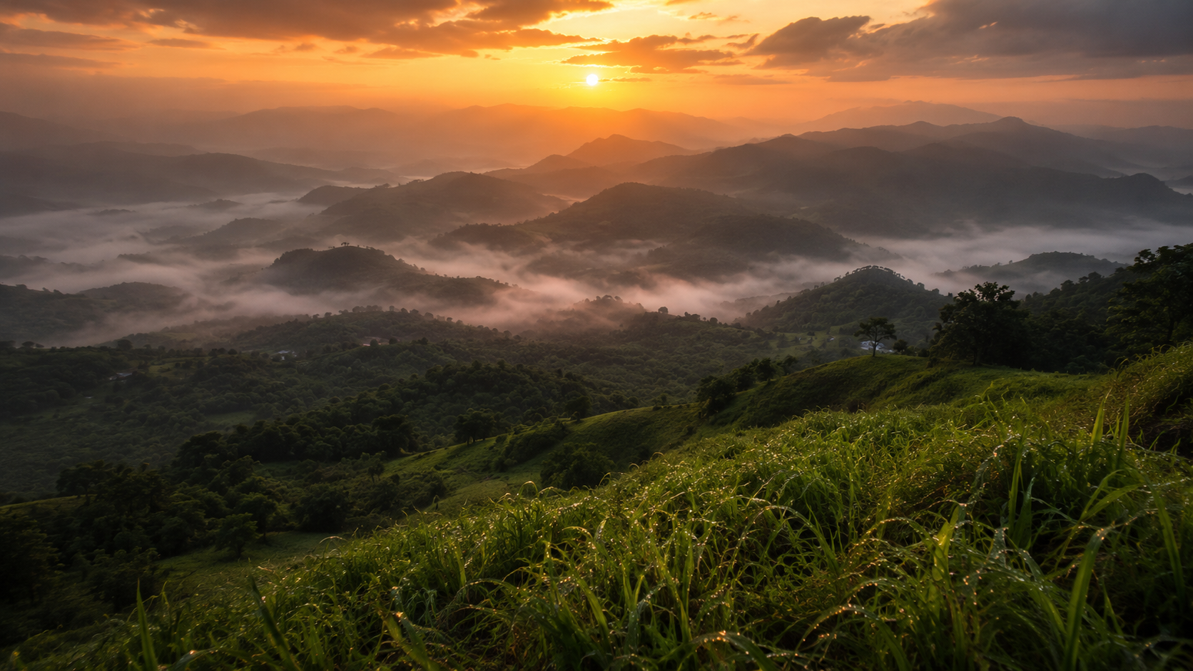 Golden-hour sunrise over a mist-filled valley in the Sahyadri range, layered hills