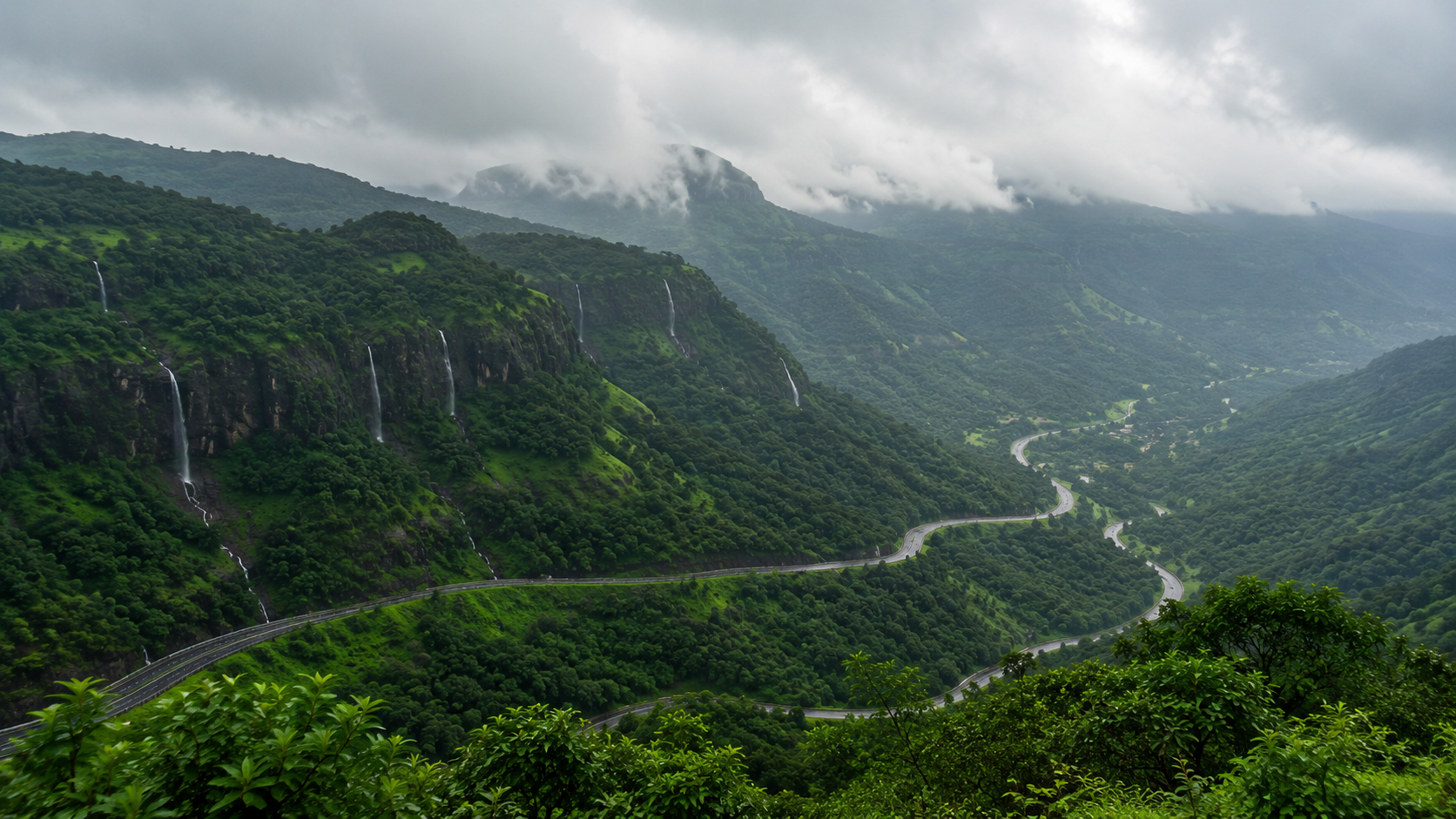 Panoramic monsoon view of the Sahyadri hills with waterfalls seen from the ghat road viewpoint
