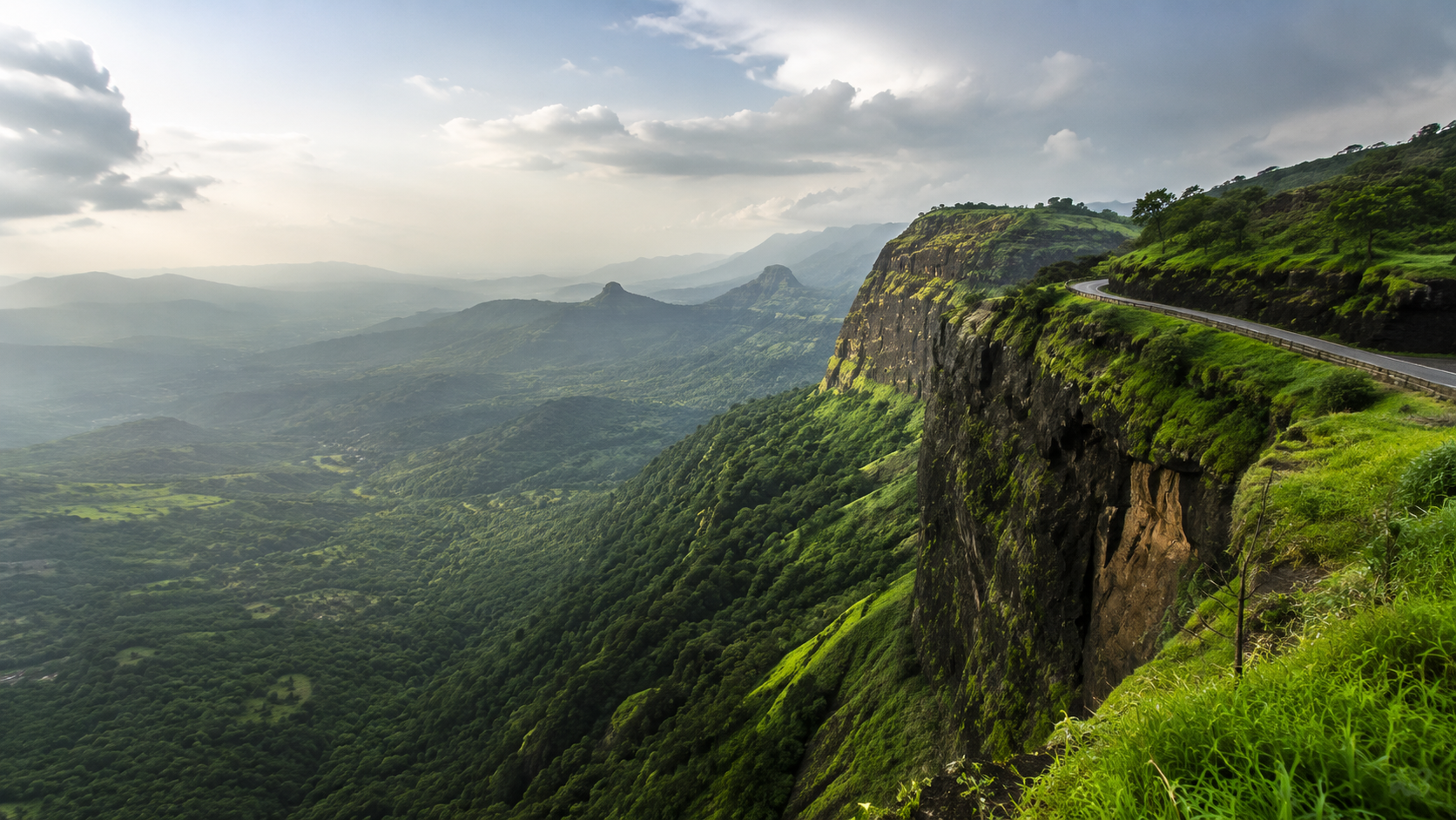Panoramic view of the Konkan valley from a cliff-edge viewpoint on the Ambenali Ghat route to Mahabaleshwar