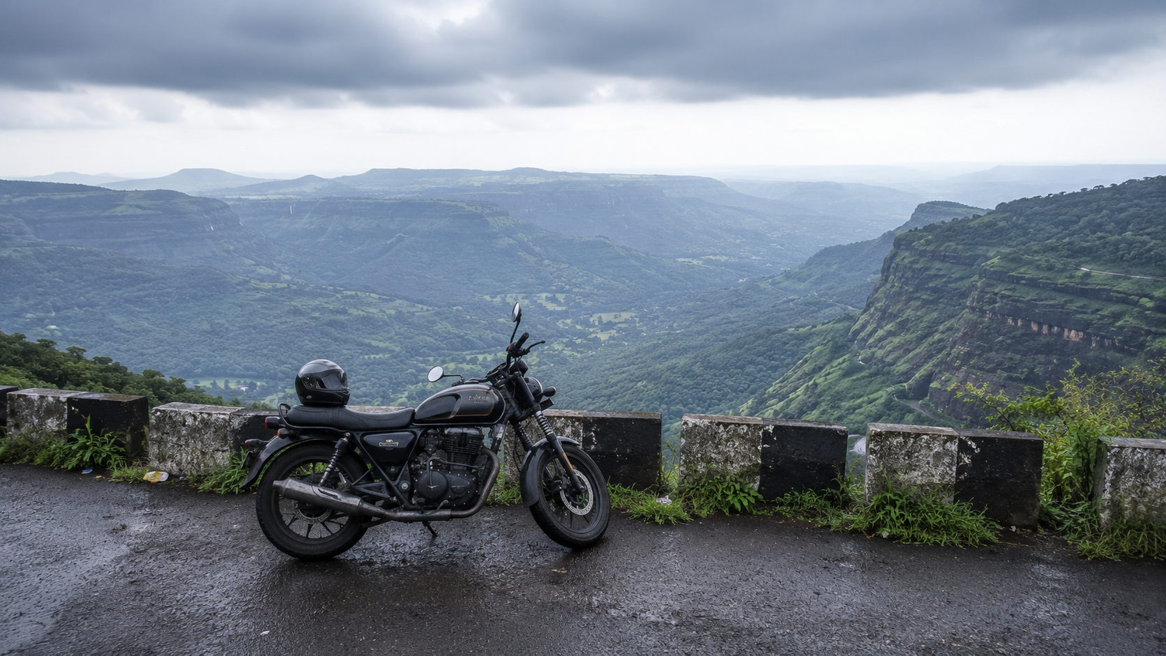 Motorbike parked at a misty ghat-road viewpoint overlooking the Konkan valley on the Ambenali Ghat route